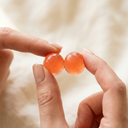 Two gummies in fingertips
